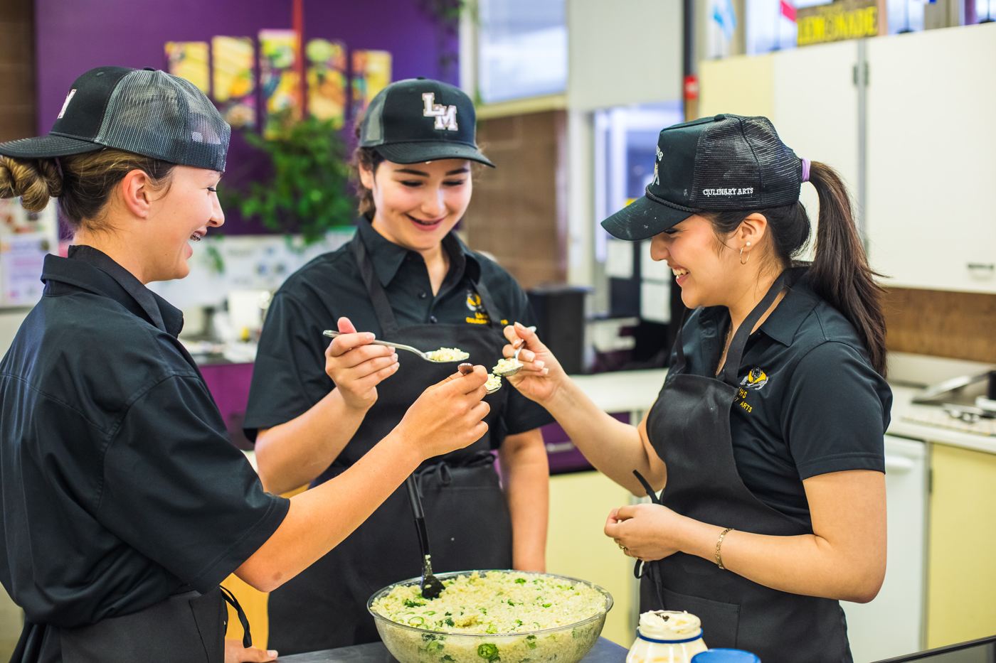 Three Los Molinos culinary arts students taste-test a dish together