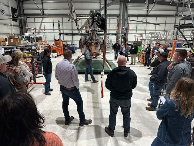 Employers and educators tour the PJ Helicopters hangar during the employer convening