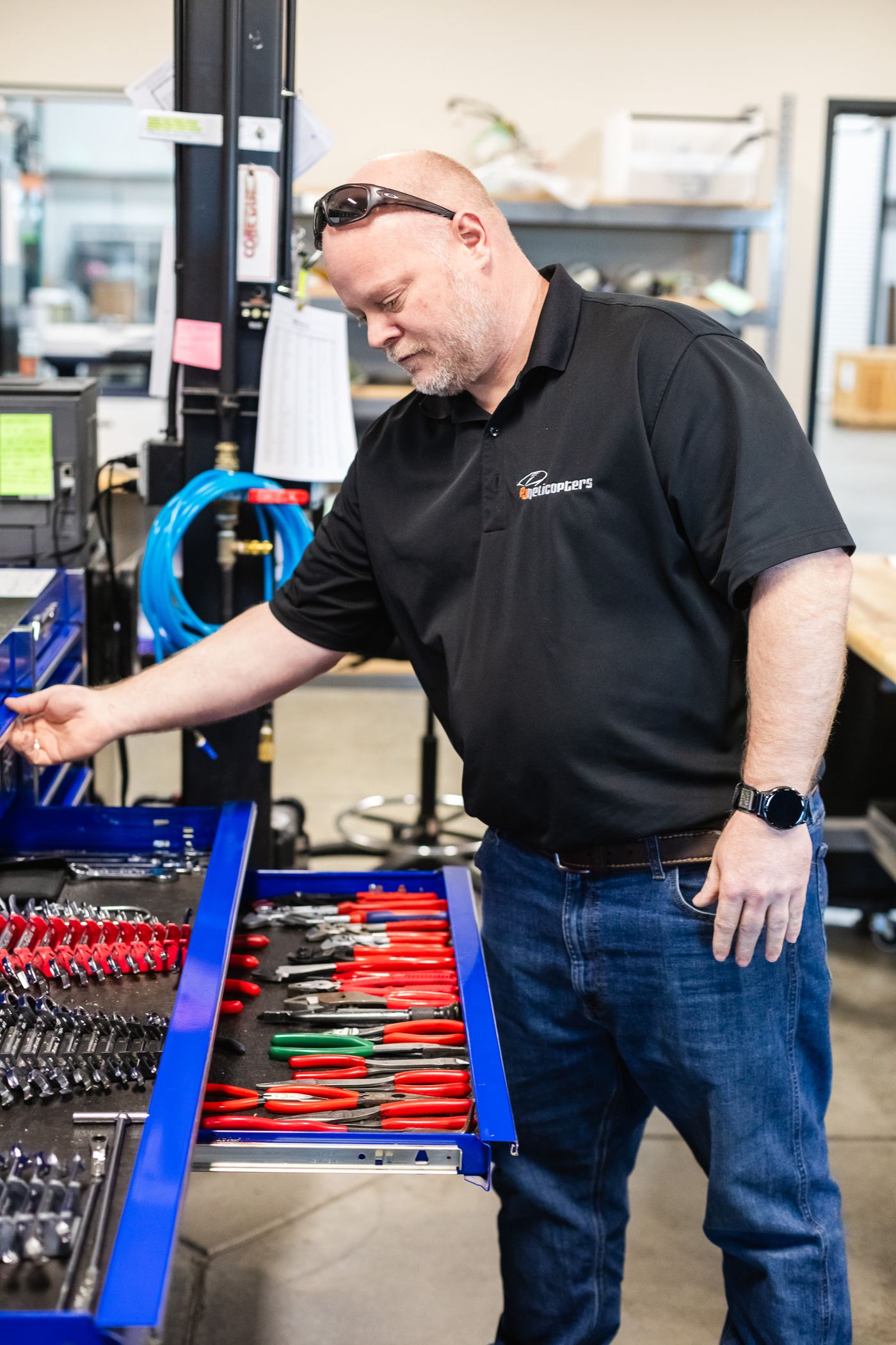 A PJ Helicopters technician at a workbench